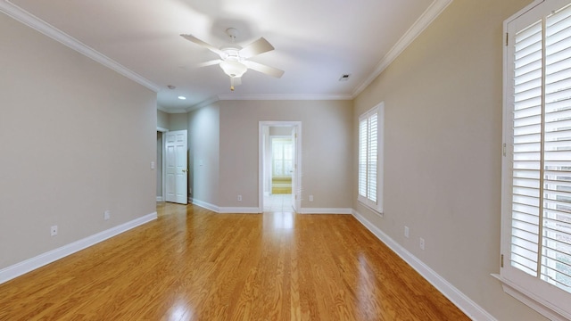 empty room with crown molding, ceiling fan, and light wood-type flooring