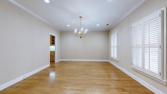 unfurnished dining area with crown molding, an inviting chandelier, and light wood-type flooring