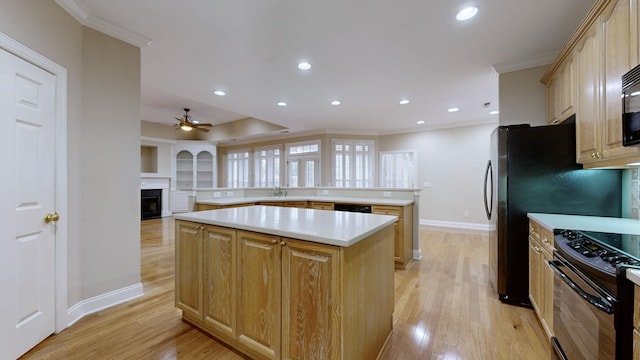 kitchen with crown molding, light hardwood / wood-style floors, black appliances, a kitchen island, and light brown cabinets