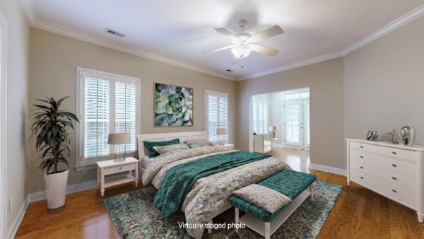 bedroom with crown molding, ceiling fan, and dark hardwood / wood-style floors