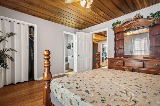 bedroom with ceiling fan, hardwood / wood-style flooring, and ensuite bathroom