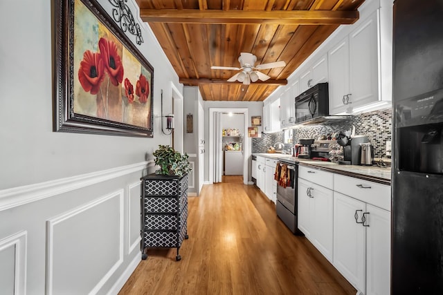 kitchen with black appliances, wood ceiling, white cabinetry, decorative backsplash, and light hardwood / wood-style floors