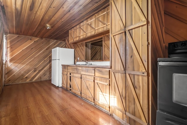 interior space featuring sink, hardwood / wood-style floors, wood walls, and wood ceiling