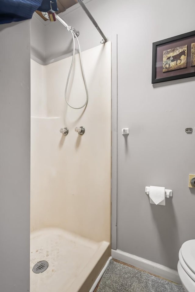 bathroom featuring toilet and walk in shower