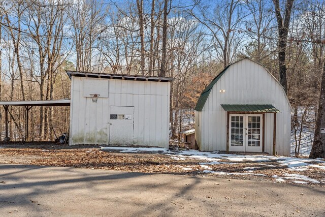 snow covered structure featuring french doors