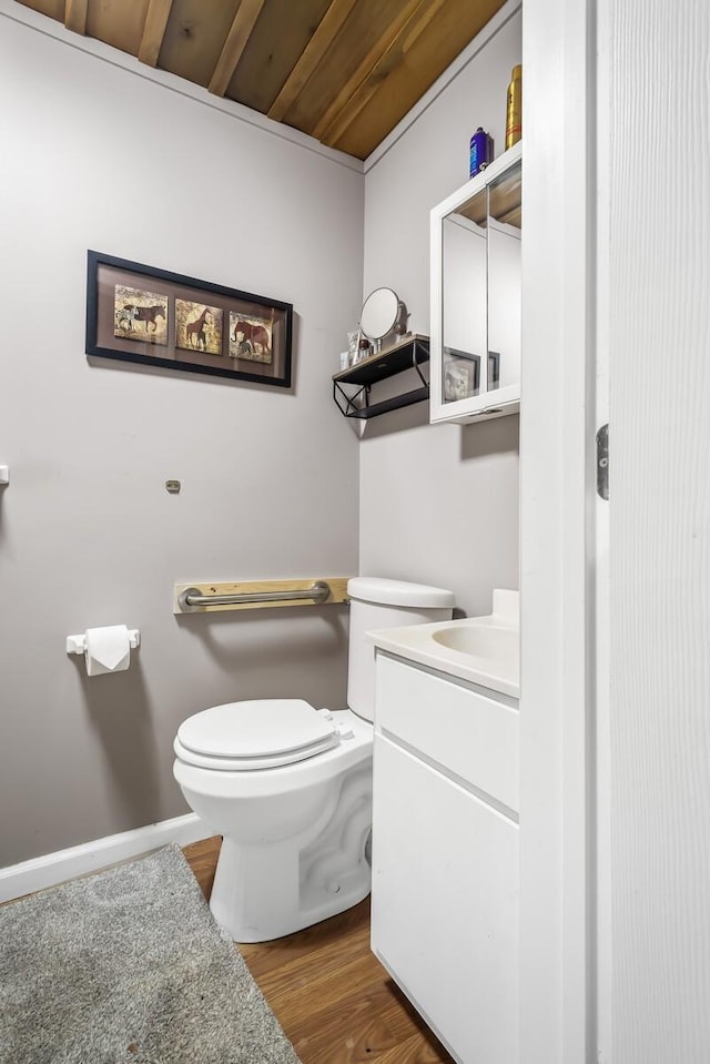 bathroom with toilet, vanity, wood ceiling, and hardwood / wood-style flooring