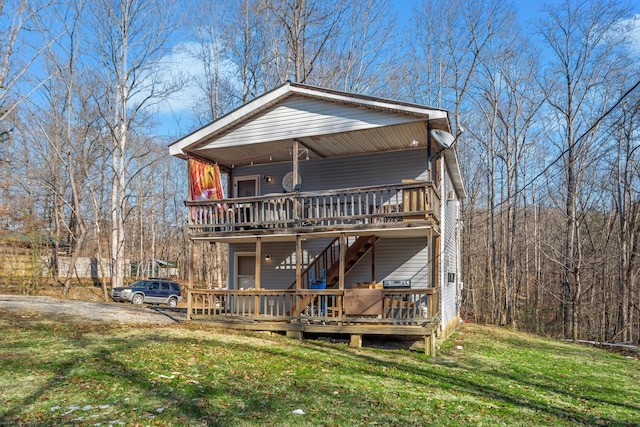 view of front of property featuring a front lawn and a deck