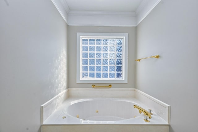 bathroom featuring crown molding and a tub