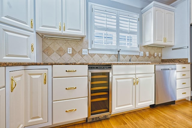 kitchen featuring wine cooler, dishwasher, decorative backsplash, white cabinetry, and dark stone counters