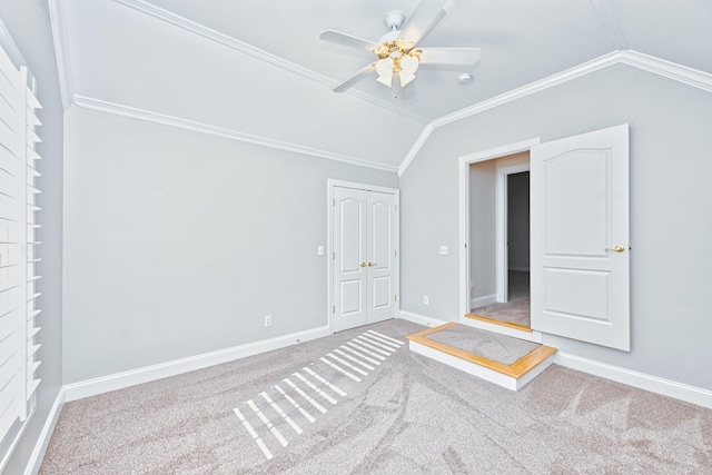 interior space with ceiling fan, carpet flooring, and vaulted ceiling