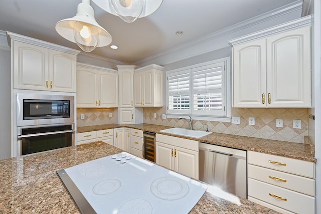 kitchen featuring decorative light fixtures, white cabinets, and stainless steel appliances