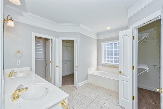 bathroom featuring a washtub, tile patterned floors, vanity, and ornamental molding