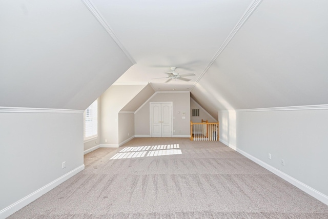 additional living space with ceiling fan, lofted ceiling, and light carpet