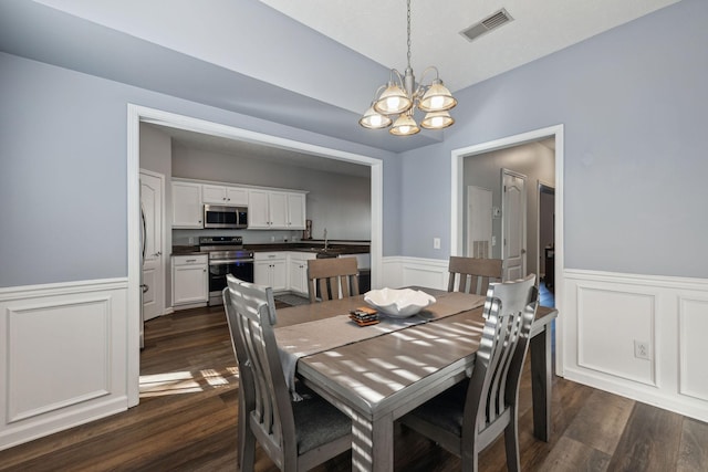 dining room featuring a chandelier, dark hardwood / wood-style flooring, and sink