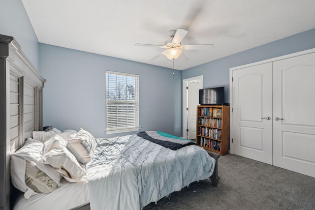 bedroom with ceiling fan, a closet, and dark carpet