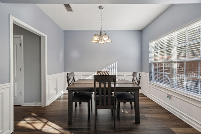 dining room featuring a chandelier and dark hardwood / wood-style floors