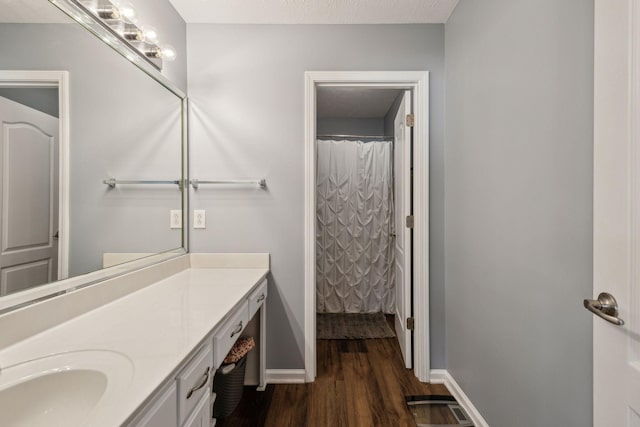 bathroom featuring hardwood / wood-style flooring, a textured ceiling, vanity, and a shower with curtain