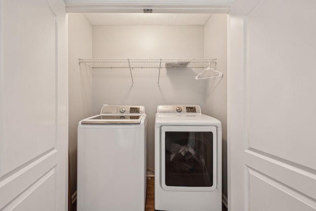 clothes washing area with separate washer and dryer