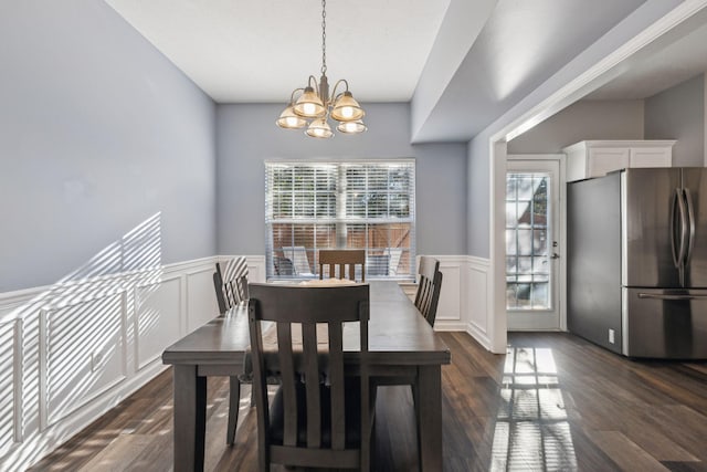 dining area featuring dark hardwood / wood-style floors and a notable chandelier