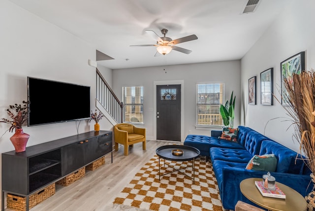 living room featuring ceiling fan and light hardwood / wood-style flooring