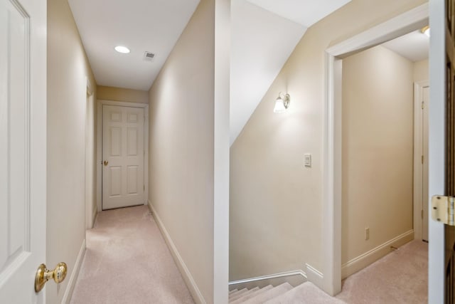 corridor featuring light carpet and lofted ceiling