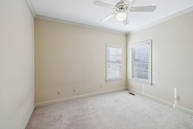 carpeted empty room featuring ceiling fan and crown molding