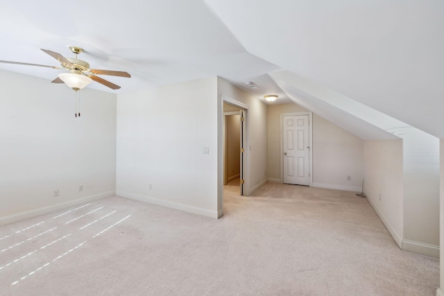 additional living space with ceiling fan, lofted ceiling, and light colored carpet