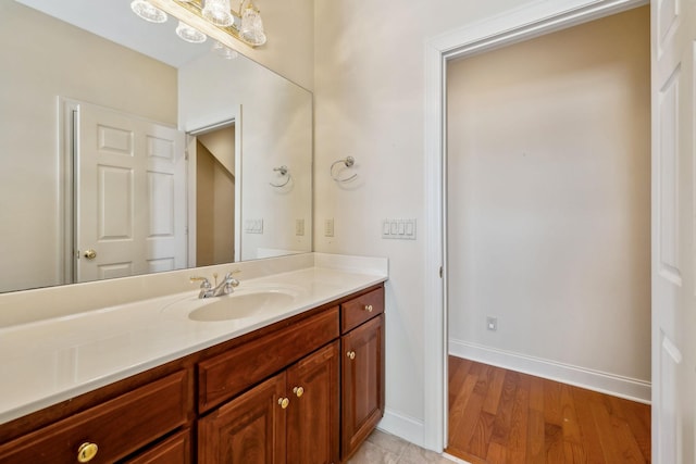 bathroom with hardwood / wood-style flooring and vanity