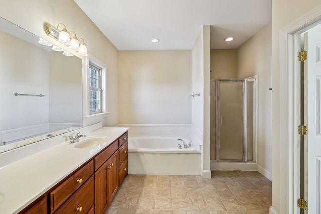 bathroom featuring vanity and shower with separate bathtub