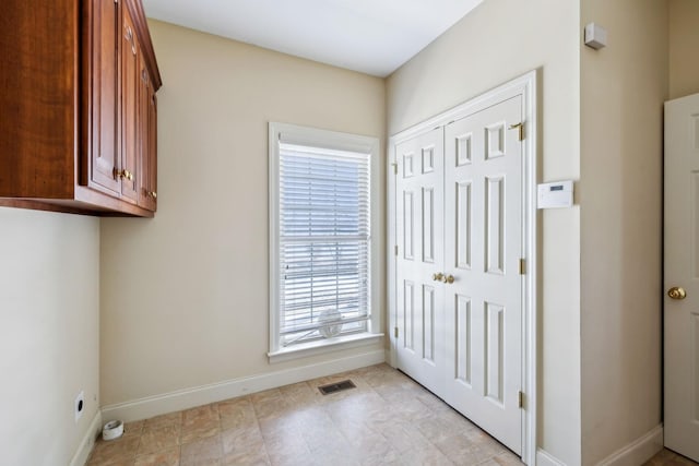 laundry area featuring cabinets