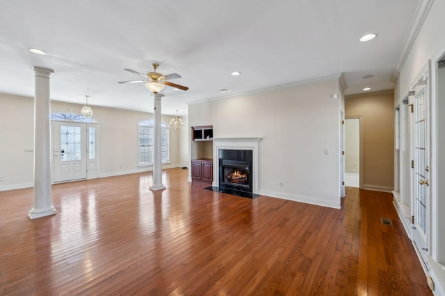 unfurnished living room featuring hardwood / wood-style flooring, ornamental molding, ornate columns, and ceiling fan