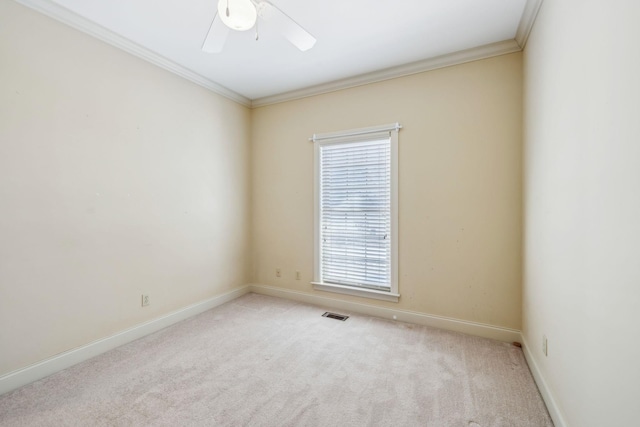 carpeted empty room featuring ceiling fan and crown molding