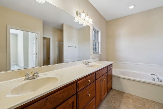 bathroom featuring vanity and independent shower and bath