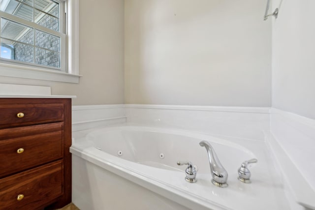 bathroom with vanity and a bath