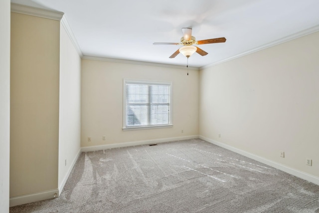 carpeted spare room with ceiling fan and crown molding