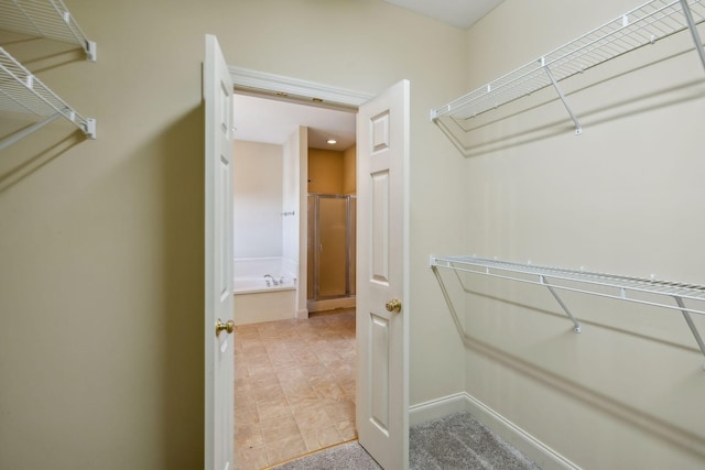 walk in closet with tile patterned floors