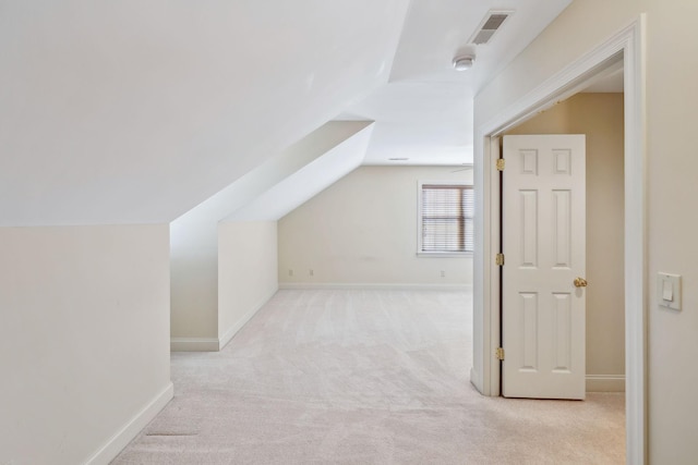 bonus room featuring lofted ceiling and light carpet