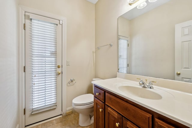 bathroom with tile patterned floors, toilet, and vanity