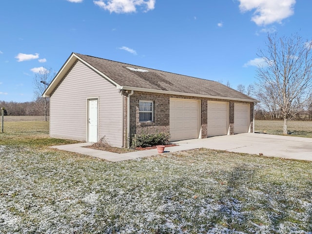 garage featuring a lawn