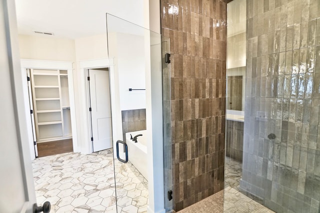 bathroom featuring shower with separate bathtub