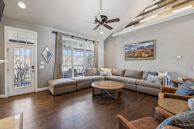 living room with ceiling fan, crown molding, dark hardwood / wood-style floors, and high vaulted ceiling