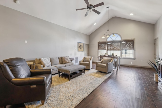 living room featuring high vaulted ceiling, dark hardwood / wood-style flooring, and ceiling fan with notable chandelier