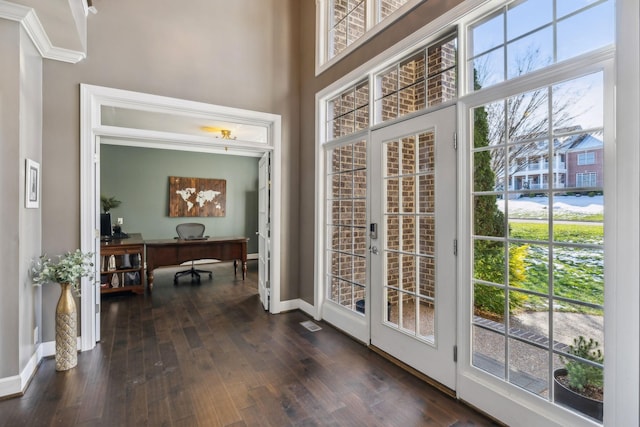 entryway featuring a high ceiling, dark hardwood / wood-style floors, and french doors