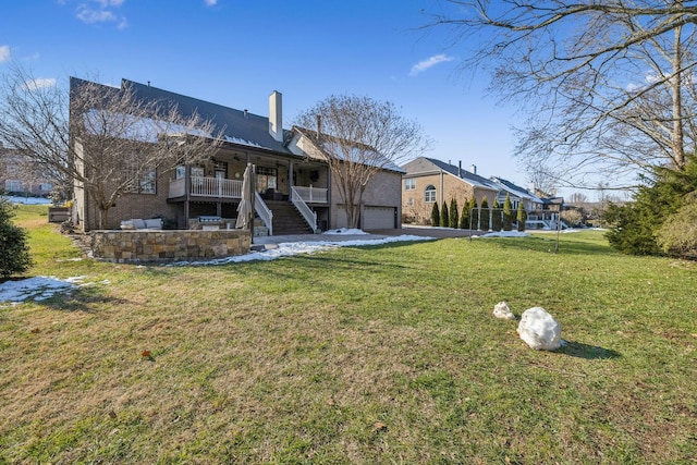 back of property featuring covered porch, a garage, and a lawn