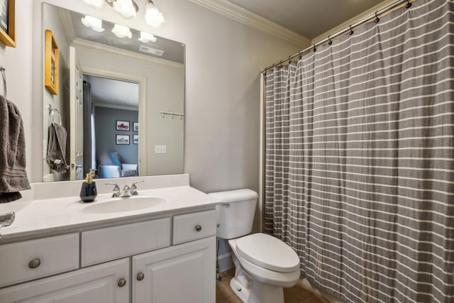 bathroom with toilet, vanity, and ornamental molding