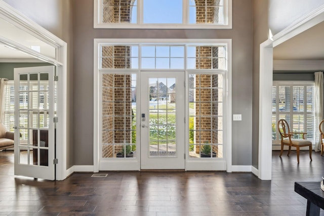 doorway featuring a high ceiling, dark wood-type flooring, and french doors