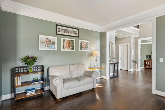 sitting room with dark hardwood / wood-style flooring and crown molding