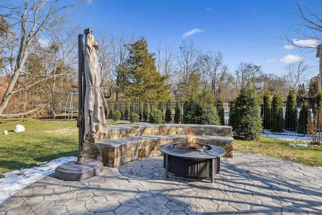 view of patio featuring a fire pit and a trampoline