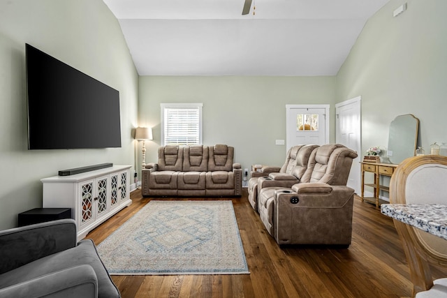 living room with ceiling fan, dark hardwood / wood-style floors, and lofted ceiling