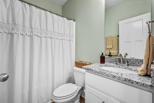 bathroom with toilet and vanity